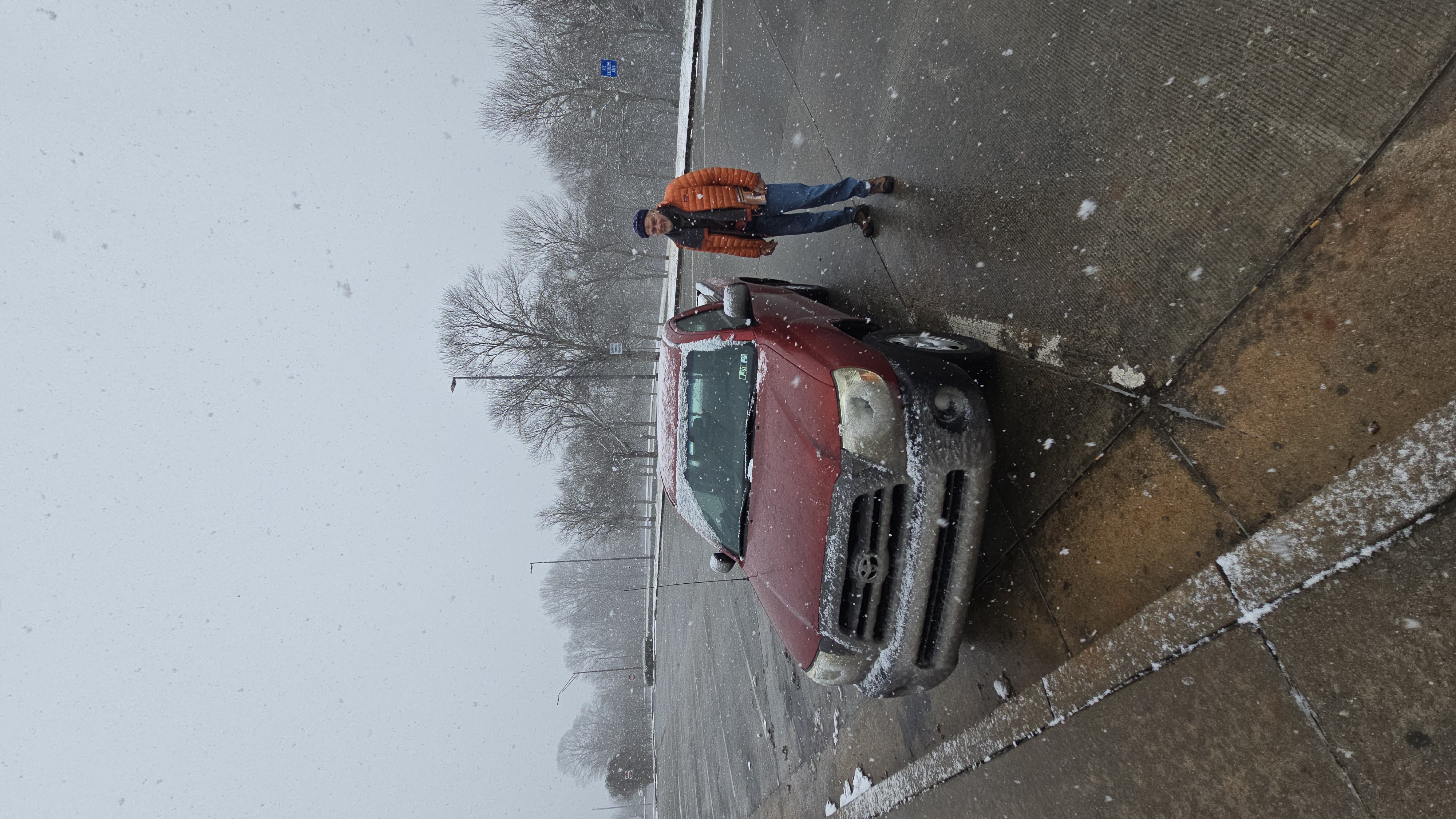 Dad standing by the snow-covered Tacoma